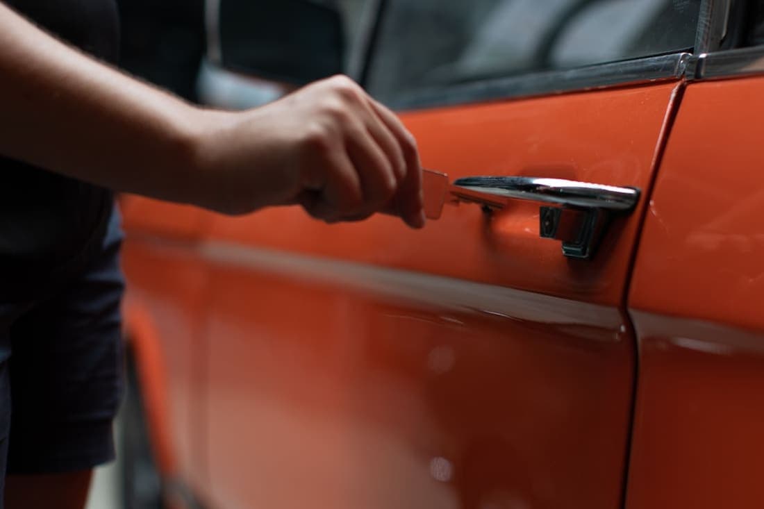 Hand opening a car door — automotive locksmith service