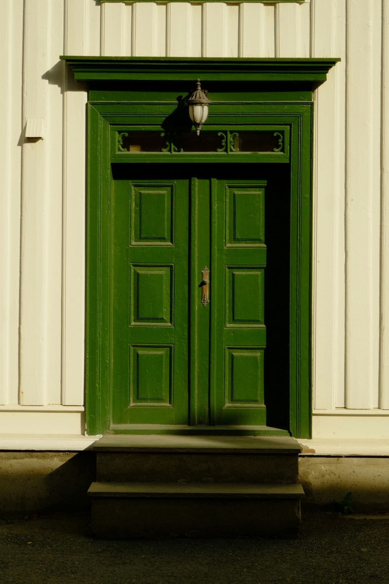 Green double doors of a residential entrance